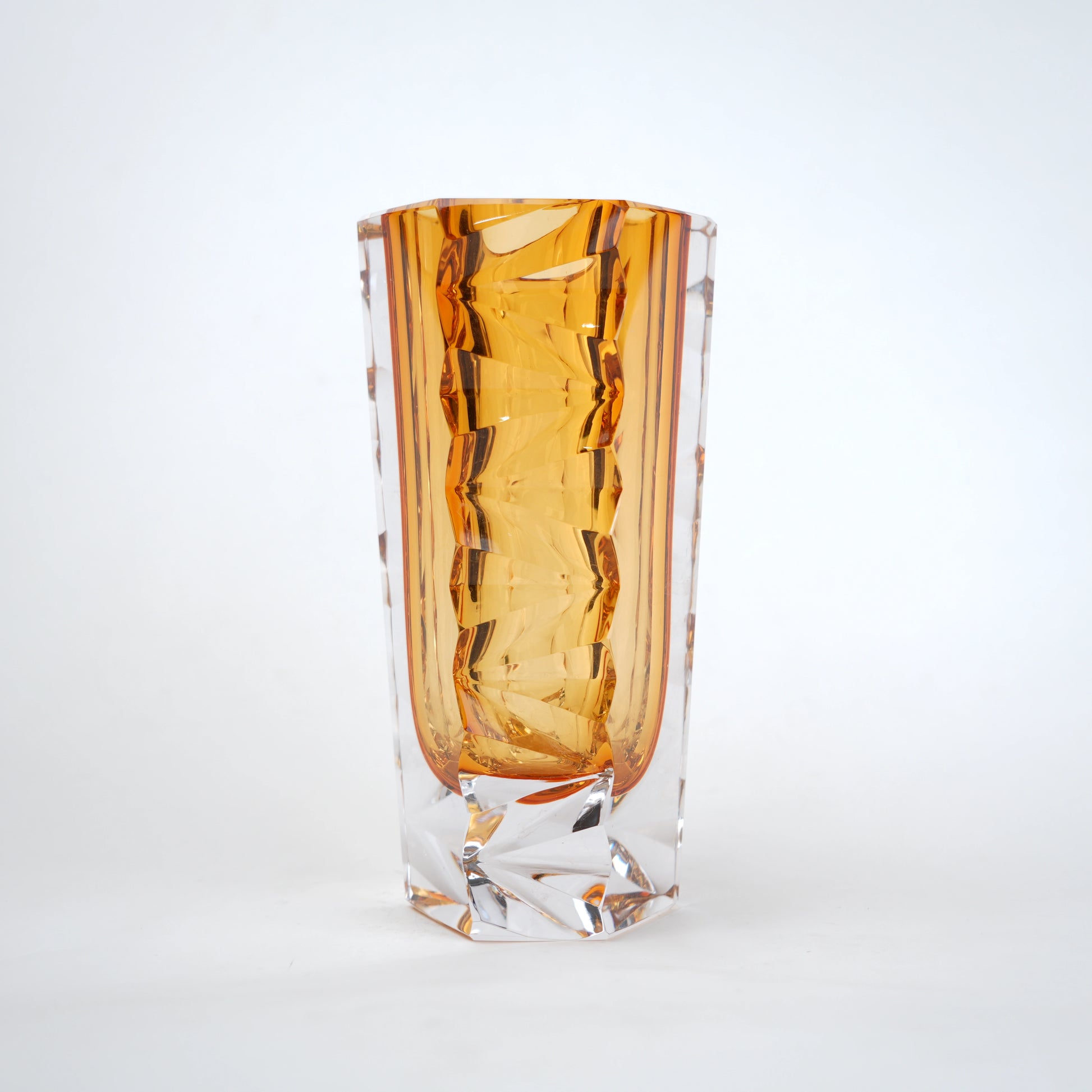 Decorative glass vase with luminous core and geometric clear glass structure