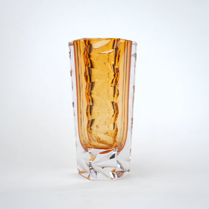 Decorative glass vase with luminous core and geometric clear glass structure