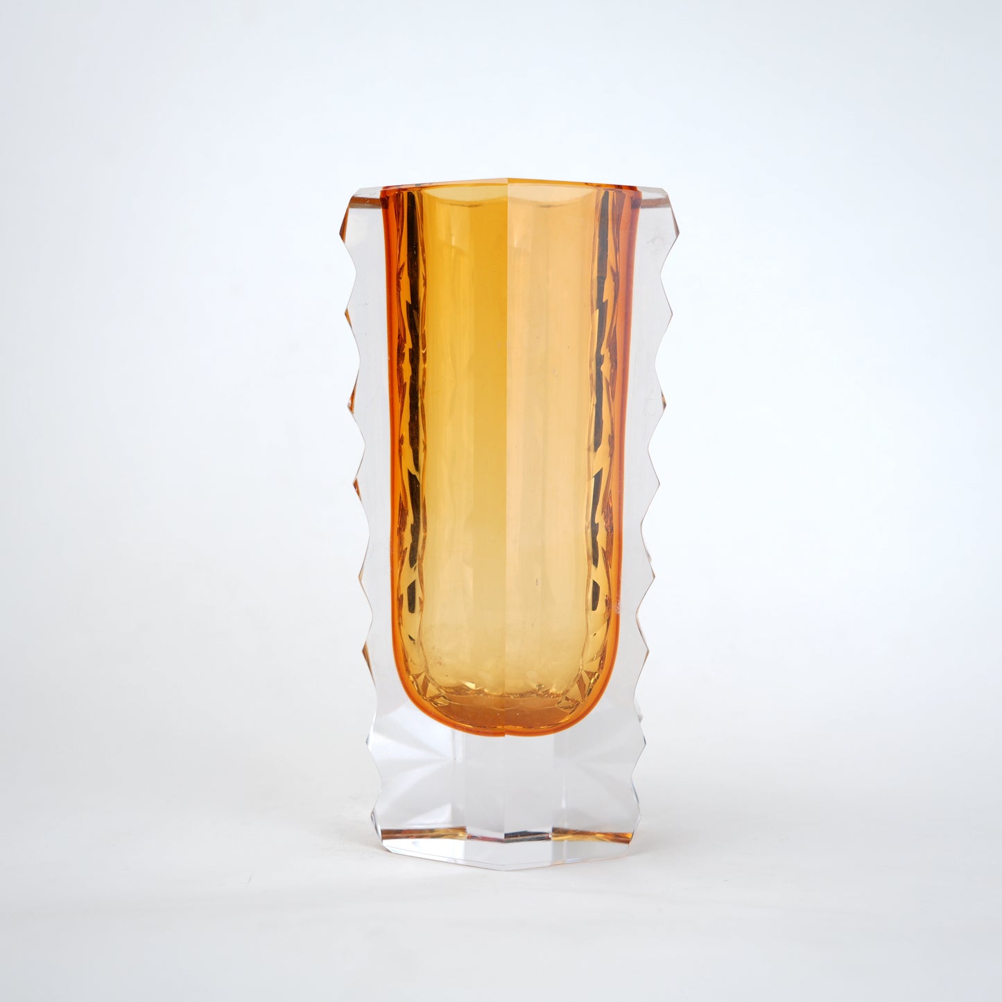 Decorative glass vase with luminous core and geometric clear glass structure