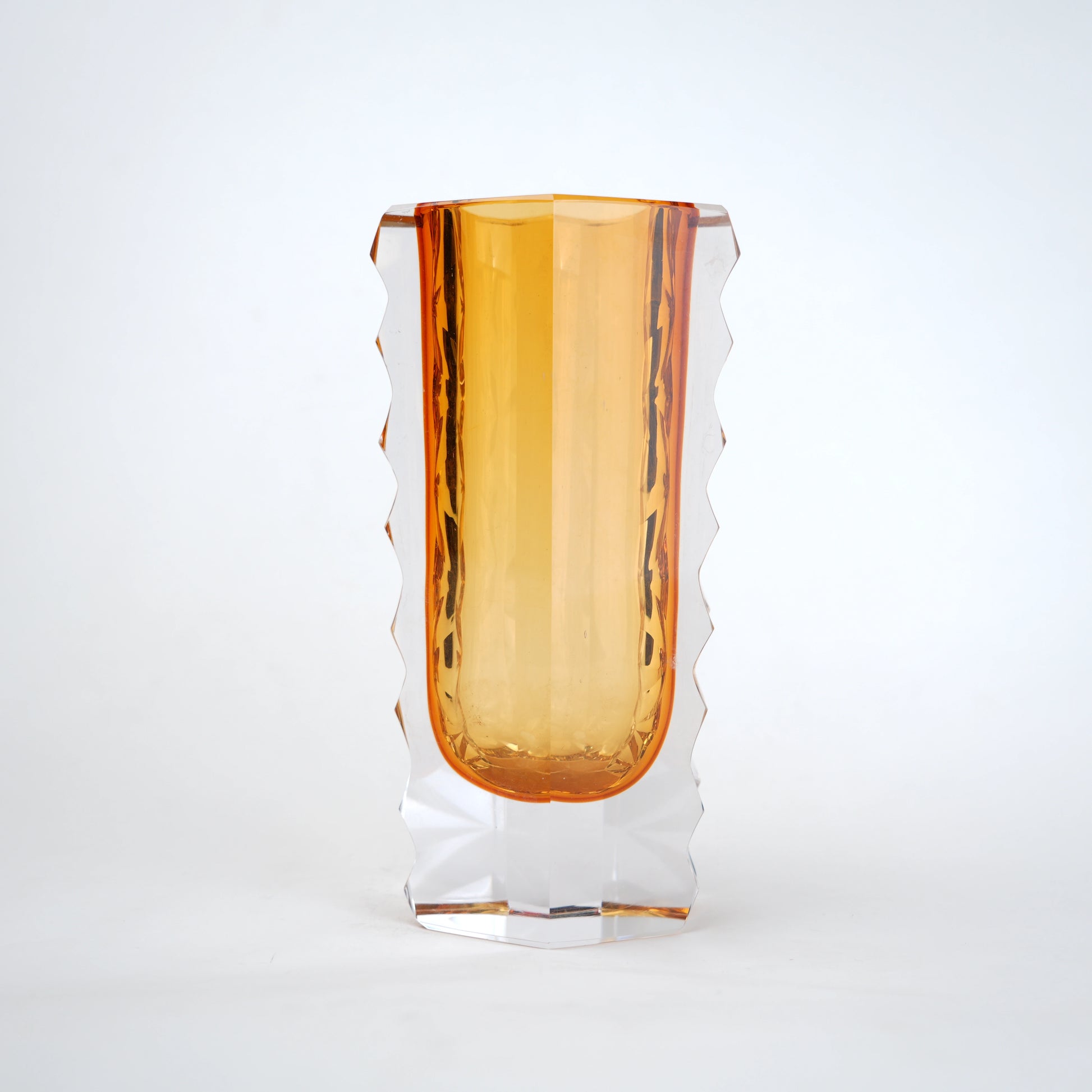 Decorative glass vase with luminous core and geometric clear glass structure