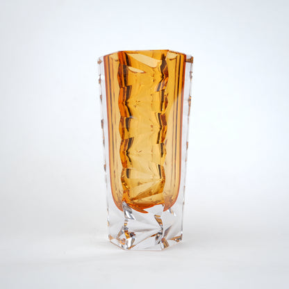 Decorative glass vase with luminous core and geometric clear glass structure