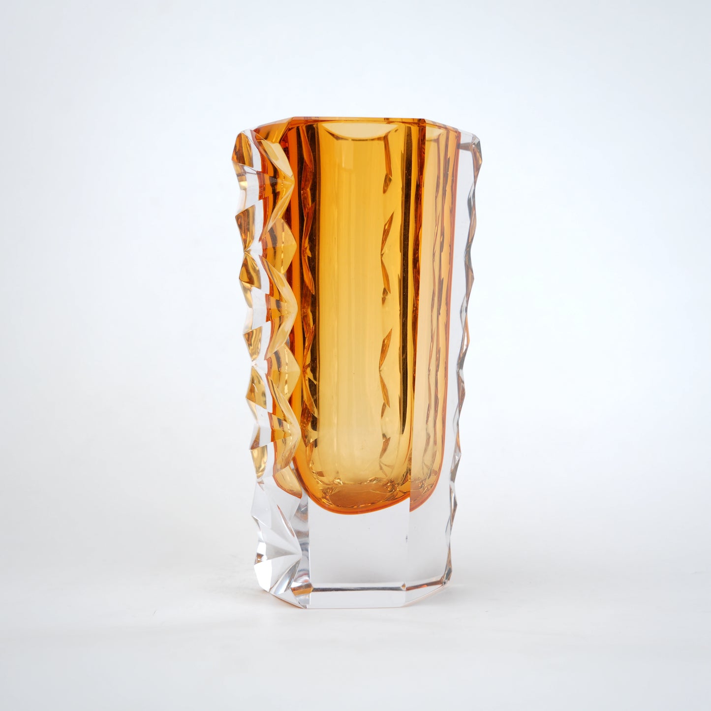 Decorative glass vase with luminous core and geometric clear glass structure