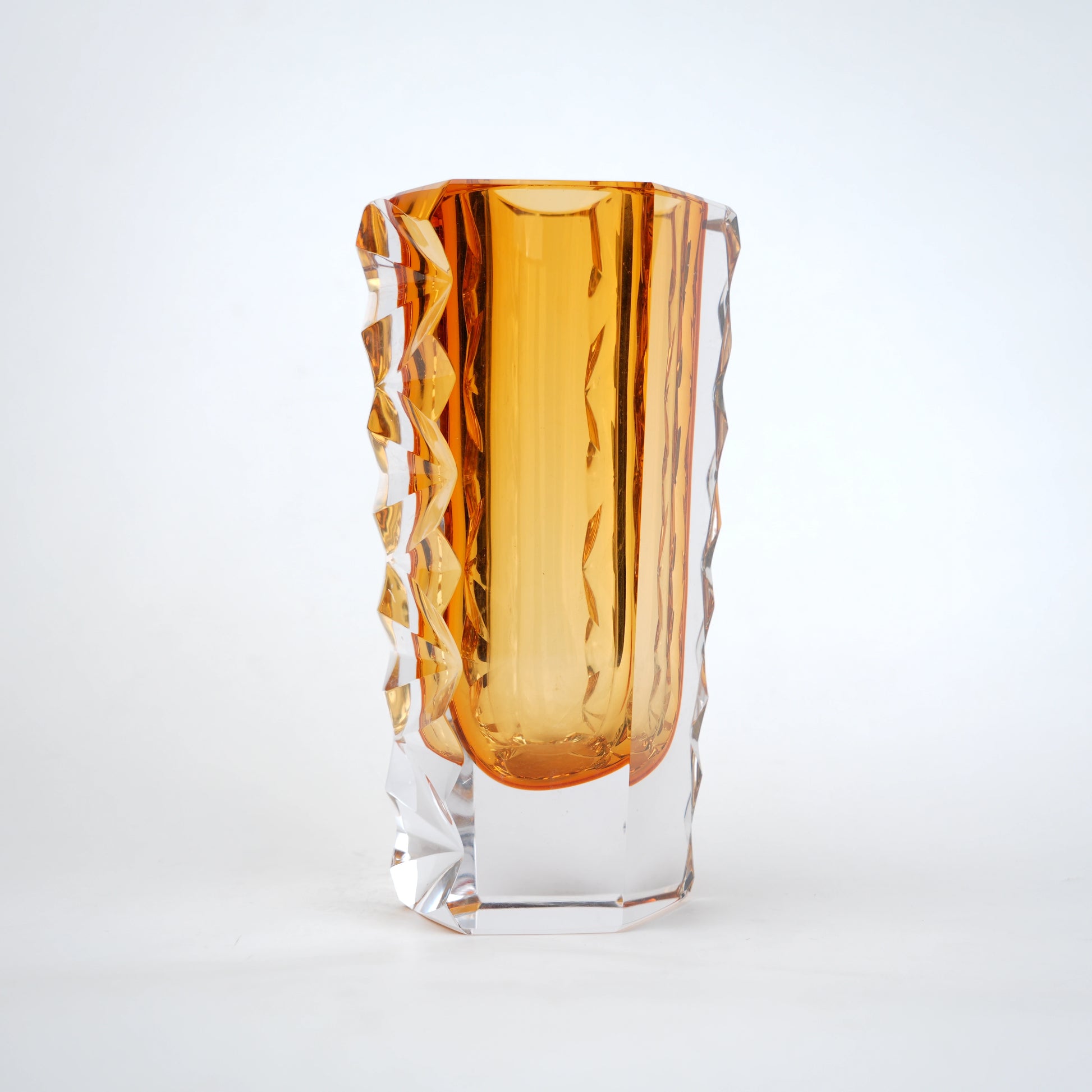 Decorative glass vase with luminous core and geometric clear glass structure
