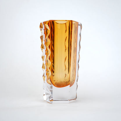Decorative glass vase with luminous core and geometric clear glass structure