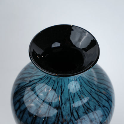 Tall blue glass vase with glossy finish featuring organic vein-like textured patterns and a gradient aqua to deep blue color transition with a flared neck design.