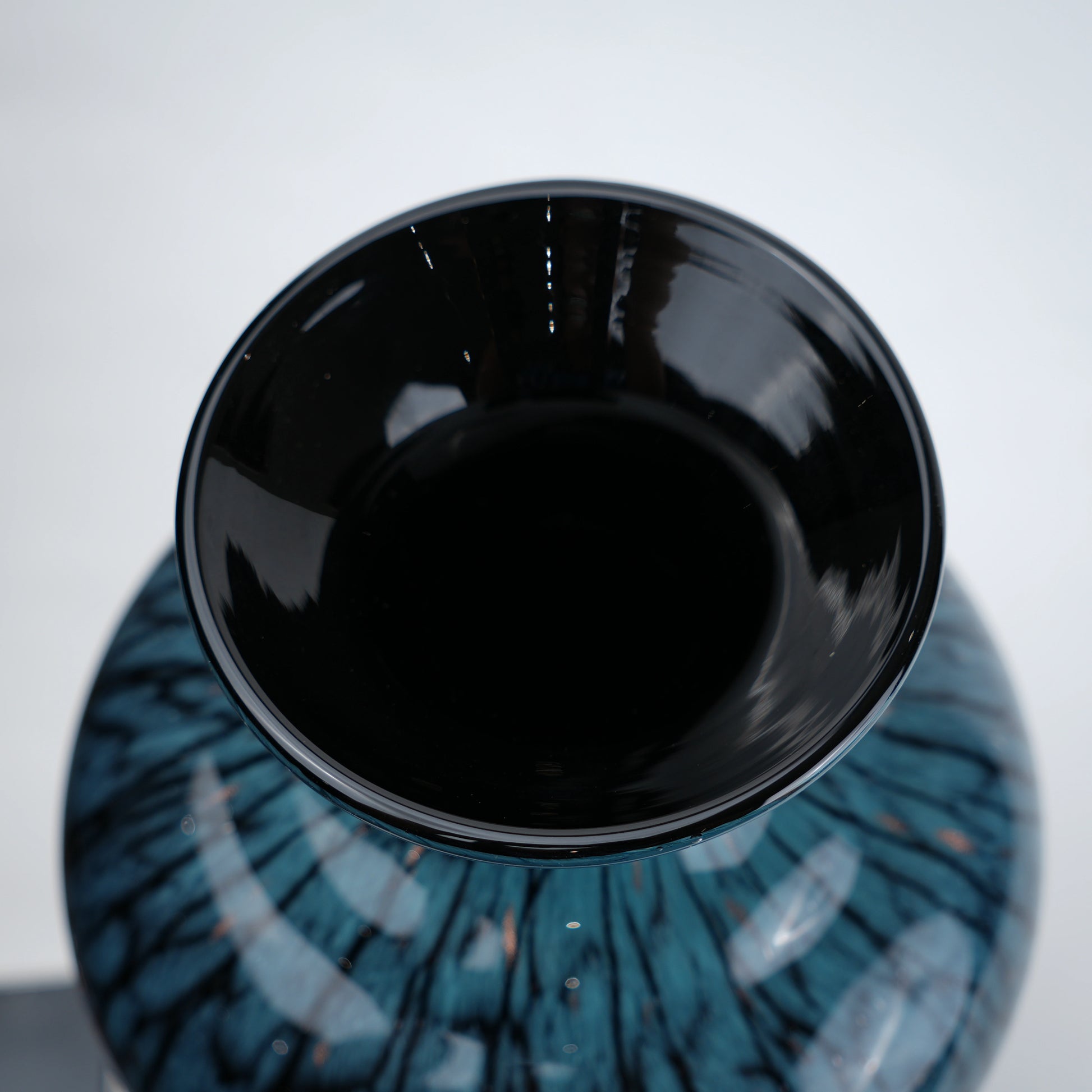 Tall blue glass vase with glossy finish featuring organic vein-like textured patterns and a gradient aqua to deep blue color transition with a flared neck design.