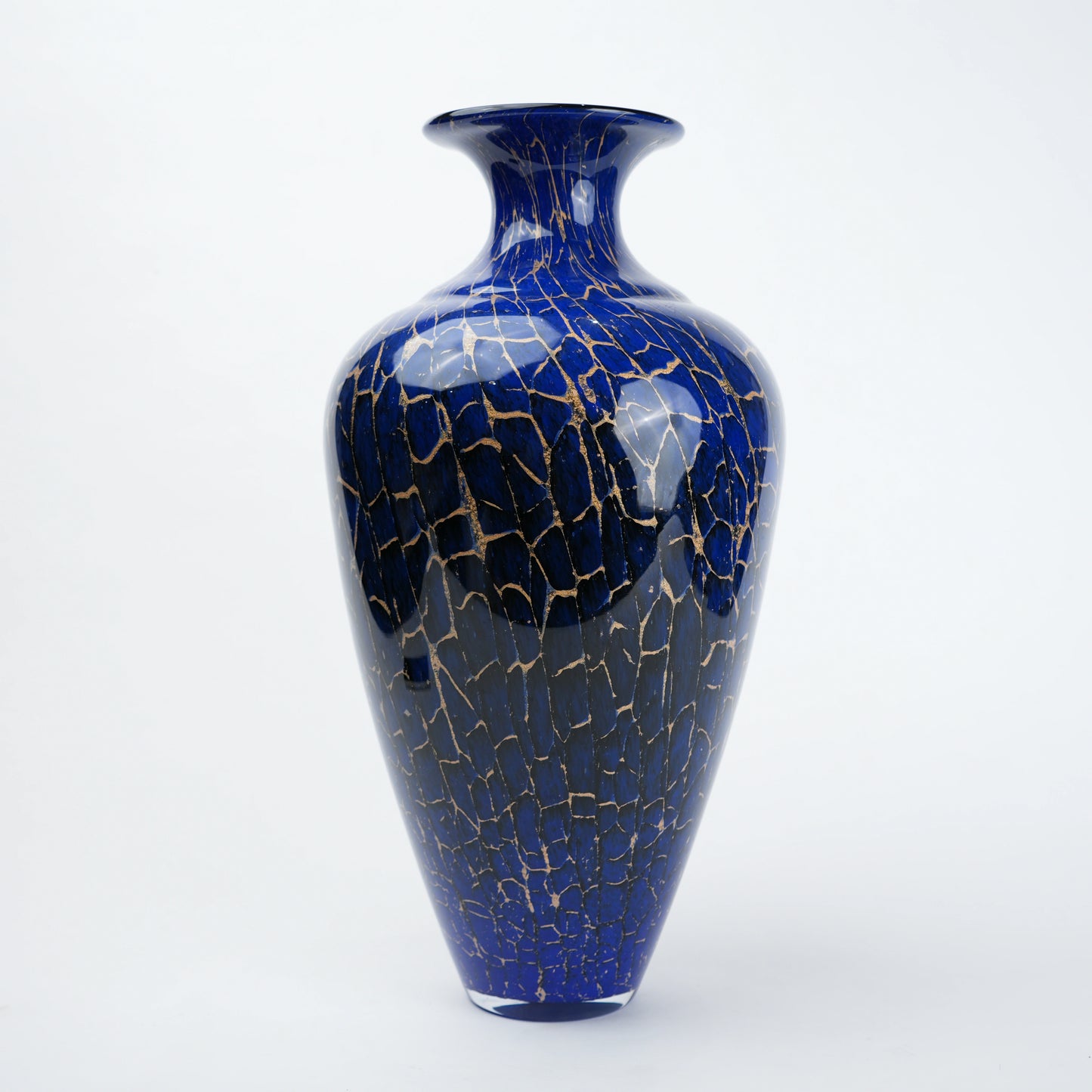 Decorative blue glass vase with deep color tone and fine gold pattern detailing designed for modern home decor