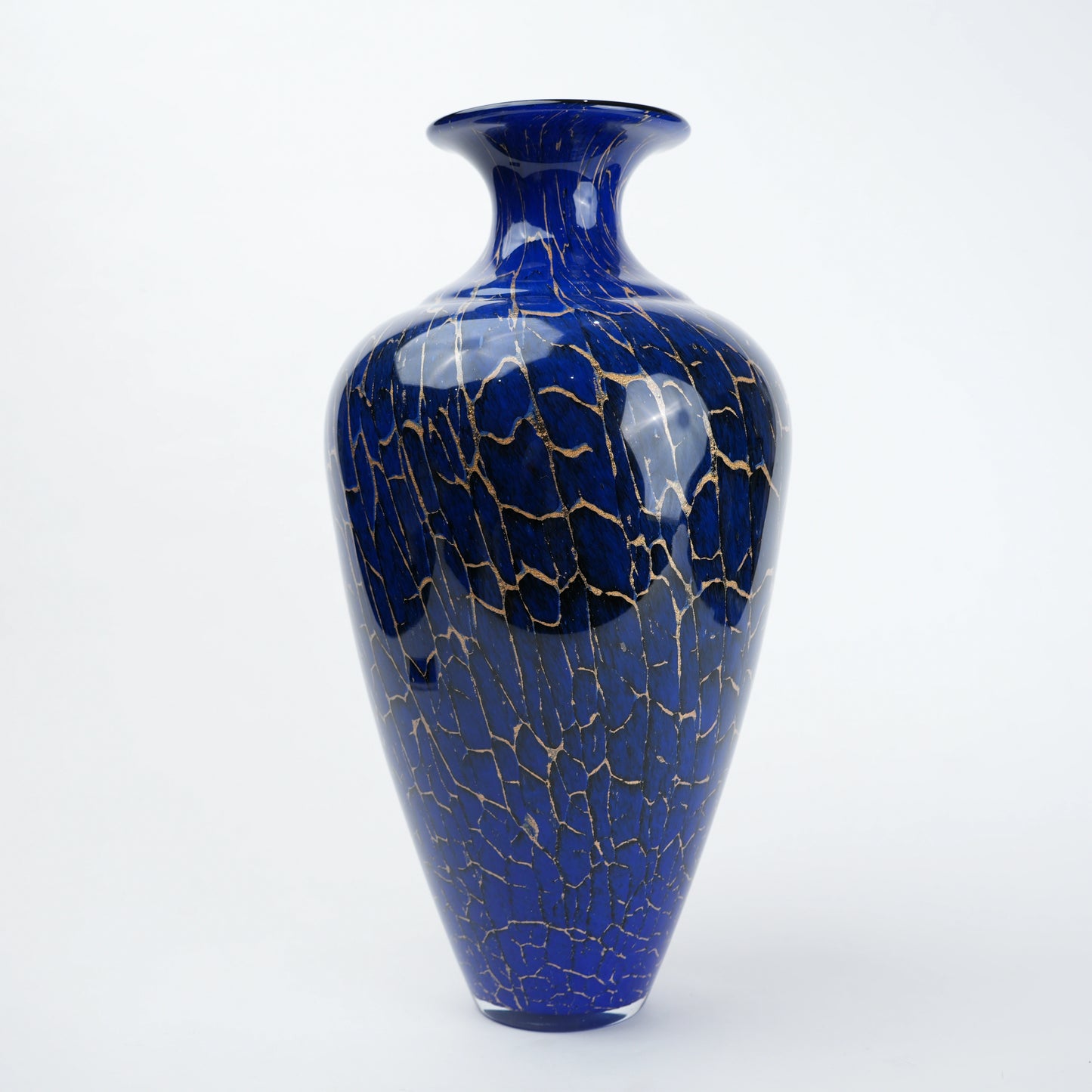 Decorative blue glass vase with deep color tone and fine gold pattern detailing designed for modern home decor