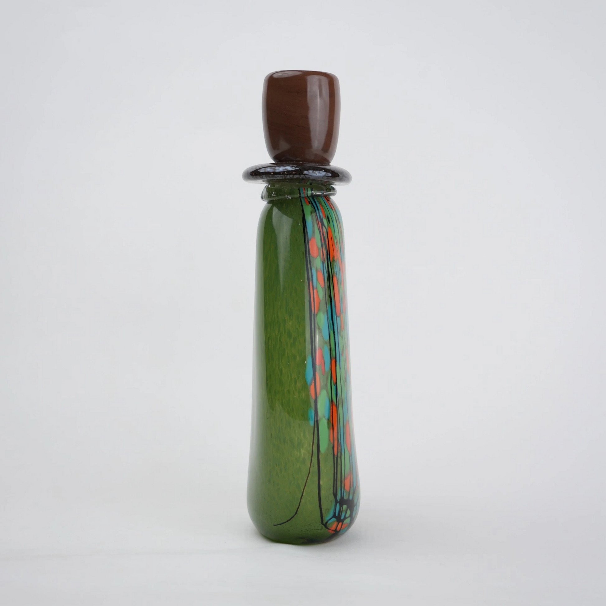 Emerald green decorative glass candle holder with orange and black drip pattern