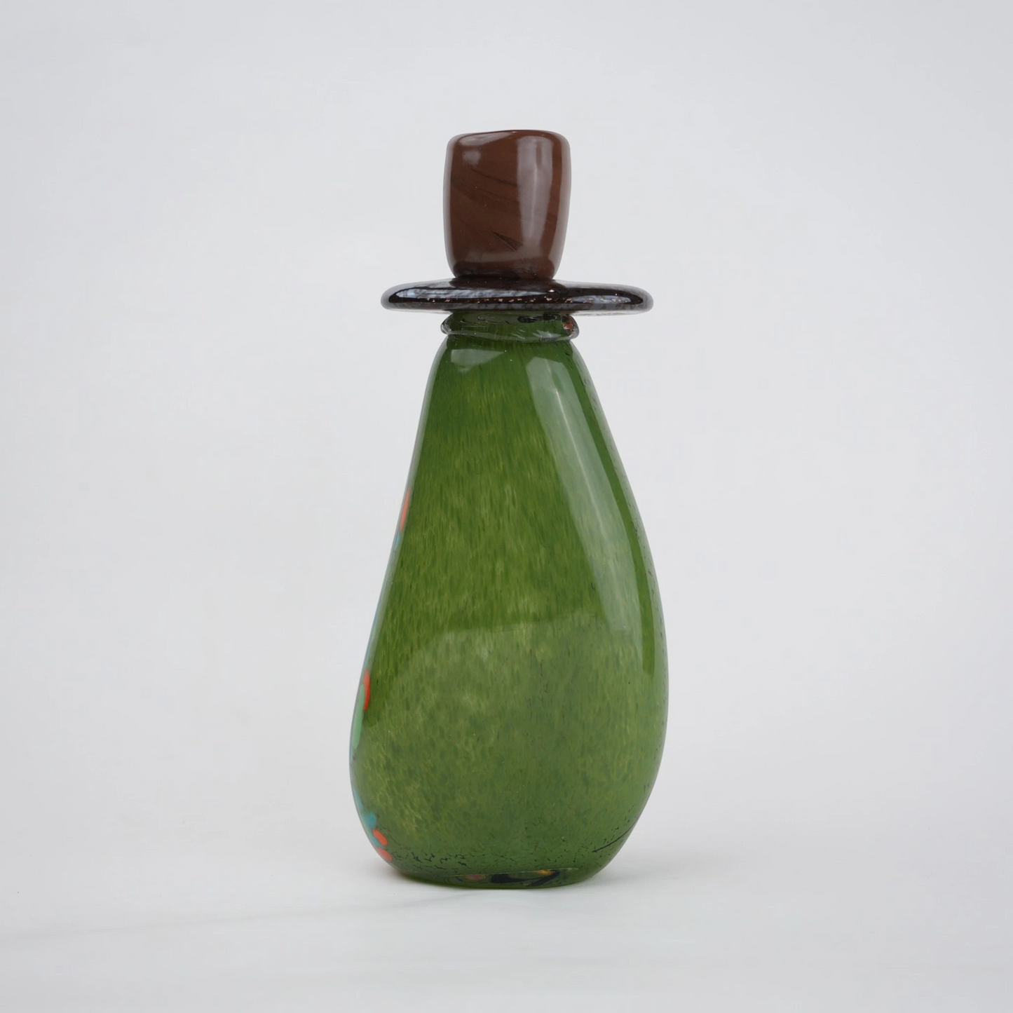 Emerald green decorative glass candle holder with orange and black drip pattern