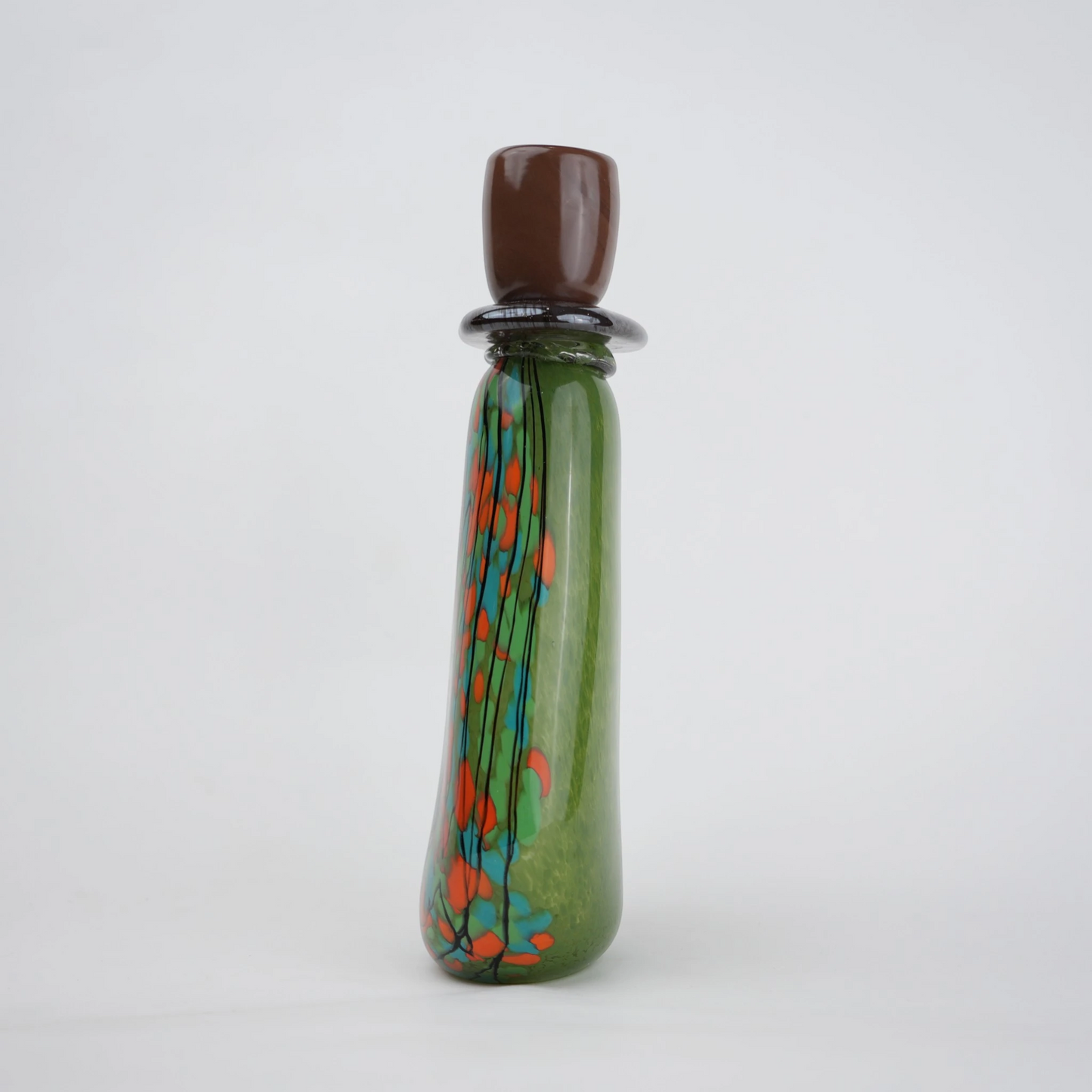 Emerald green decorative glass candle holder with orange and black drip pattern