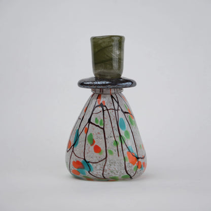 multicolor abstract glass candle holder with orange green accents and black drip design