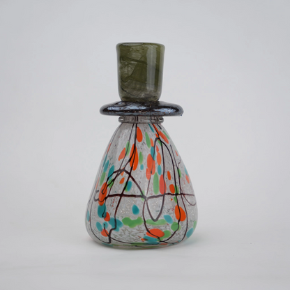 multicolor abstract glass candle holder with orange green accents and black drip design