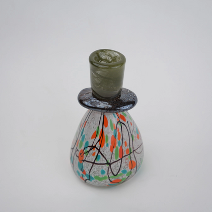 multicolor abstract glass candle holder with orange green accents and black drip design