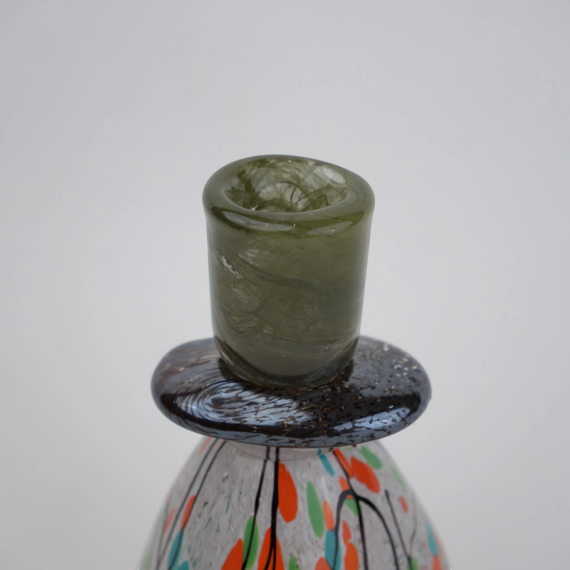 multicolor abstract glass candle holder with orange green accents and black drip design