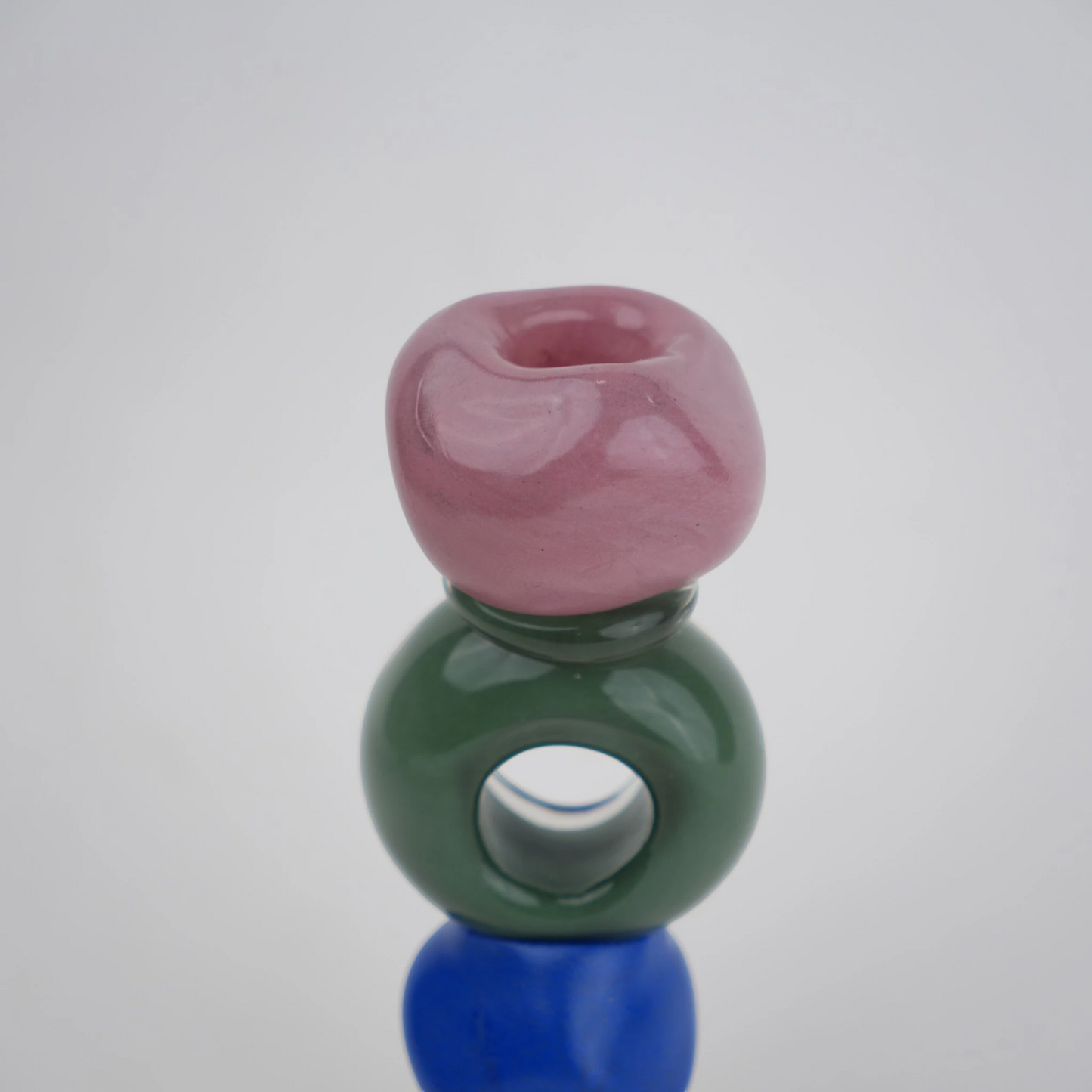Colorful totem glass candle holder with stacked geometric design and circular ring center