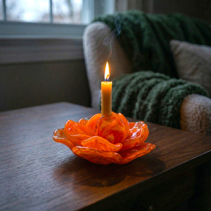 Orange flower holder lit, dark wood close-up