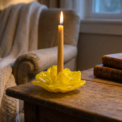 Yellow flower holder lit beside cream sofa