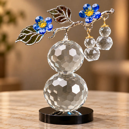 clear crystal decorative piece with floral detailing and metal leaves