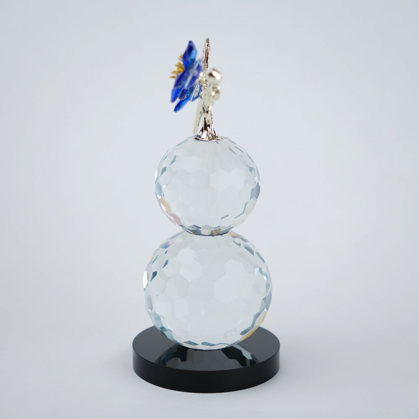 clear crystal decorative piece with floral detailing and metal leaves