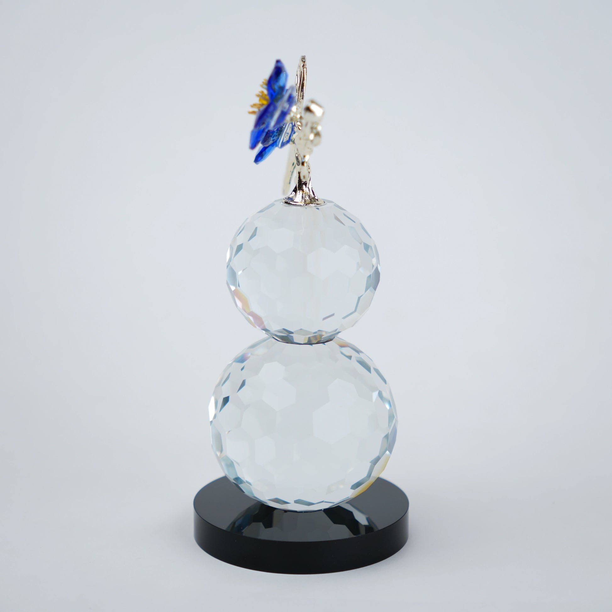 clear crystal decorative piece with floral detailing and metal leaves