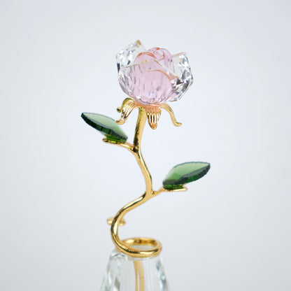 Decorative crystal flower with pink petal and gold stem on a white background