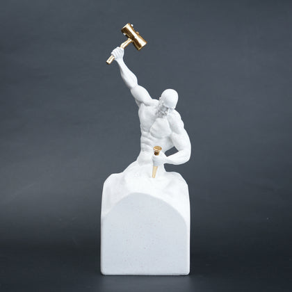Victory climber figurine with a muscular human form standing on a rock, holding a hammer raised overhead and a tool in the other hand, symbolizing strength, determination, and achievement.