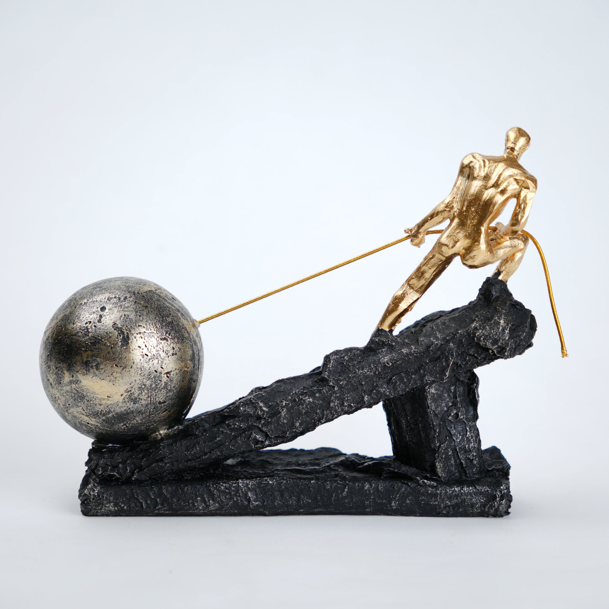 Abstract resin figurine of man pulling ball artistic tabletop decor