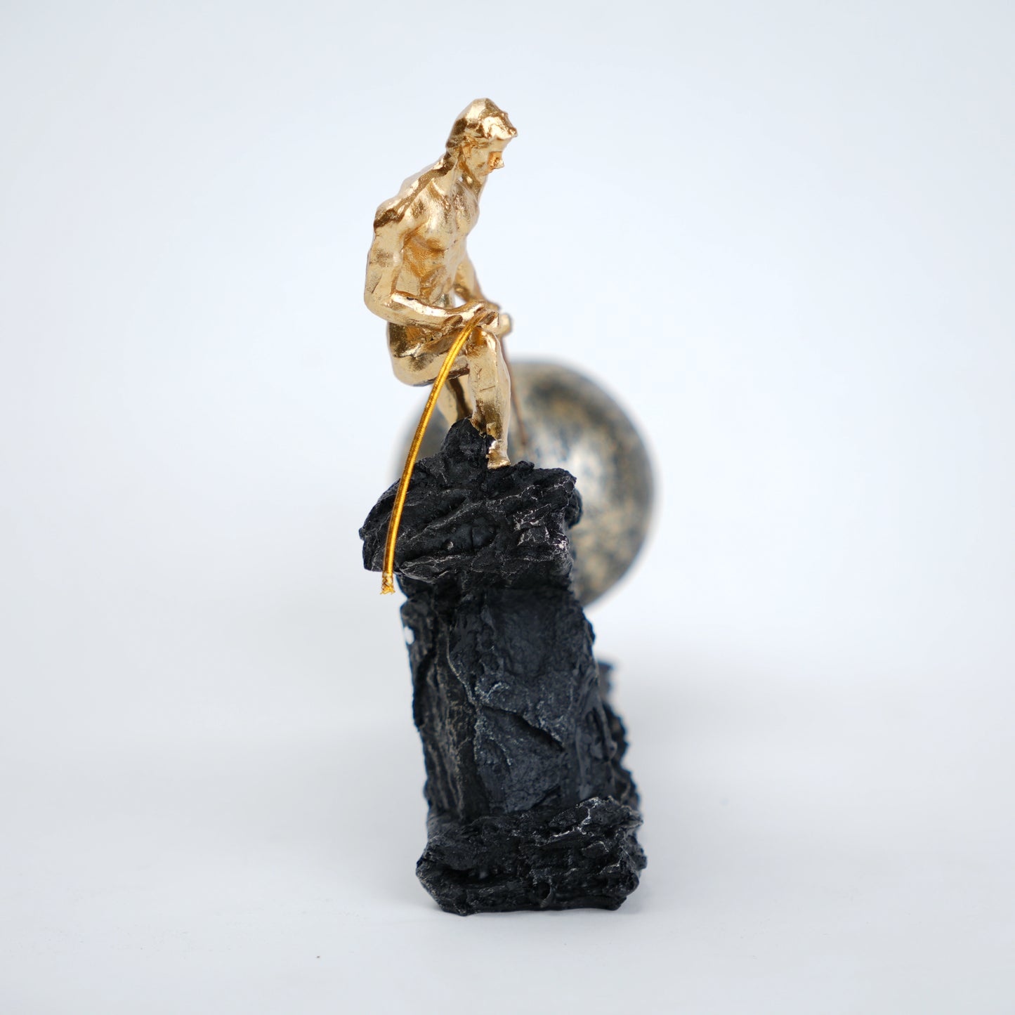 Abstract resin figurine of man pulling ball artistic tabletop decor