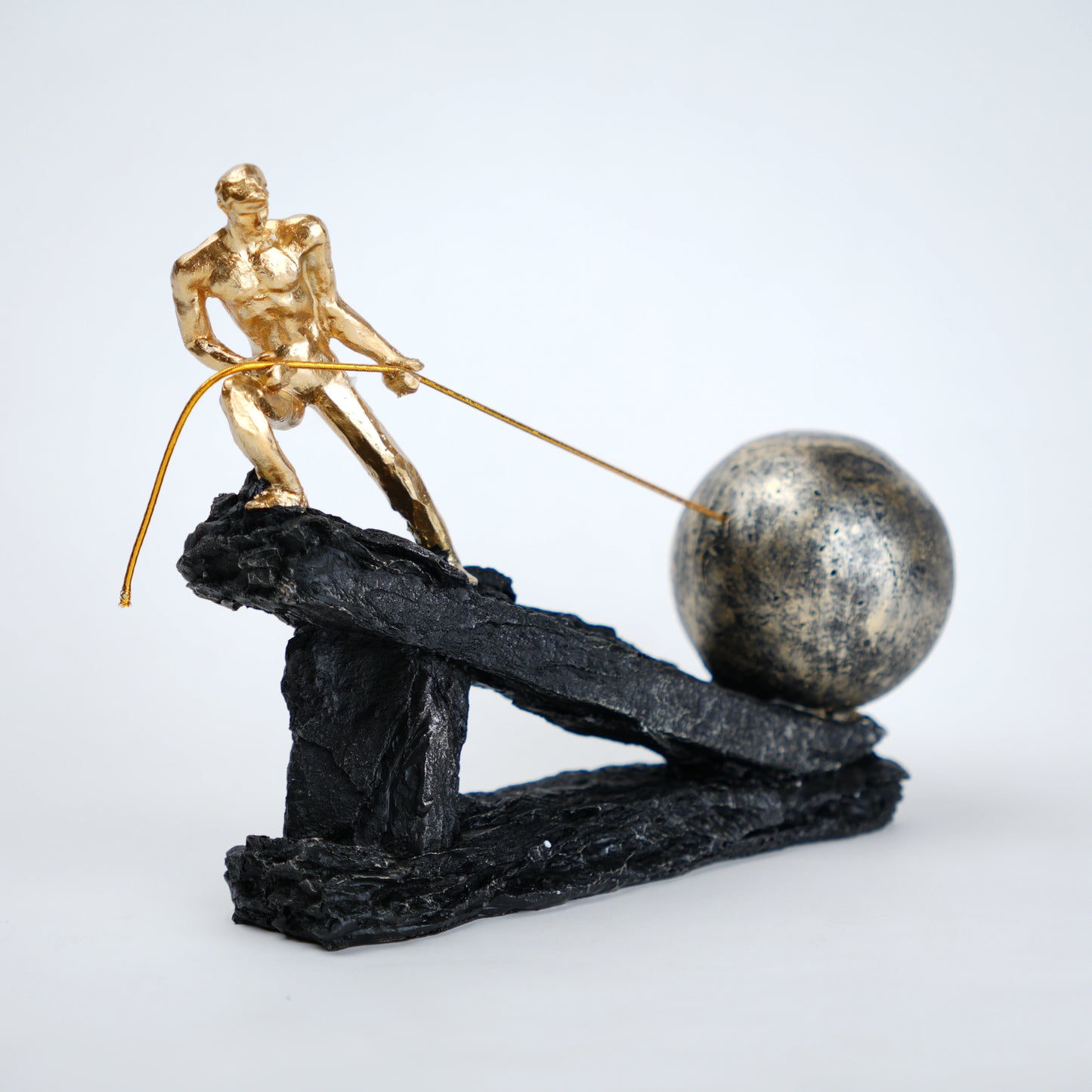 Abstract resin figurine of man pulling ball artistic tabletop decor