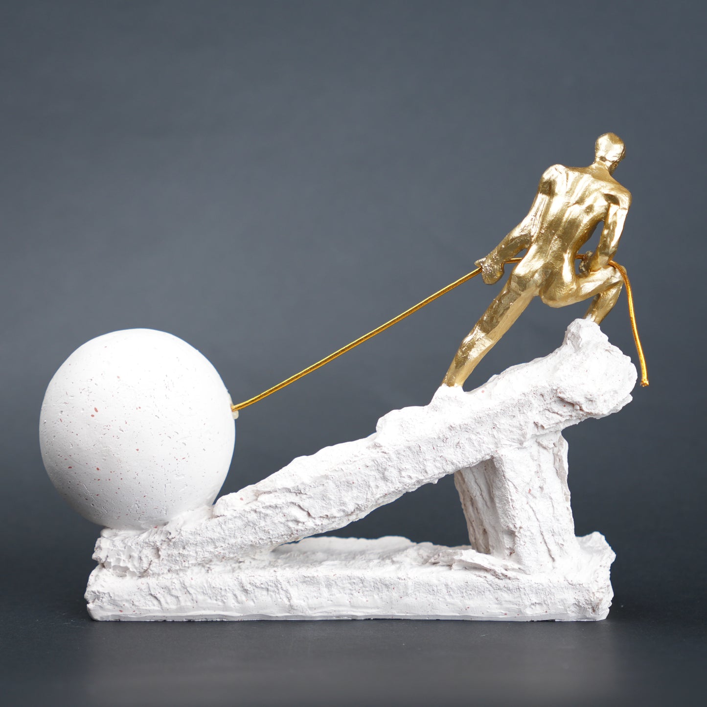 Abstract resin figurine of man pulling ball artistic tabletop decor