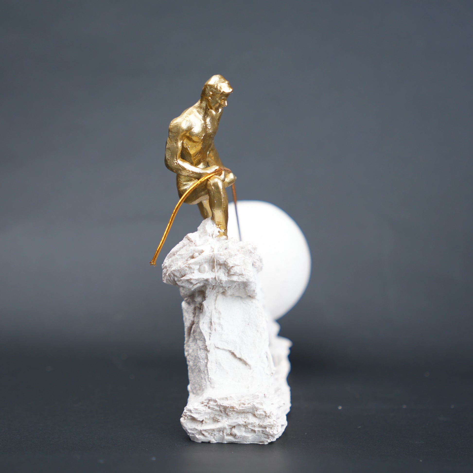 Abstract resin figurine of man pulling ball artistic tabletop decor