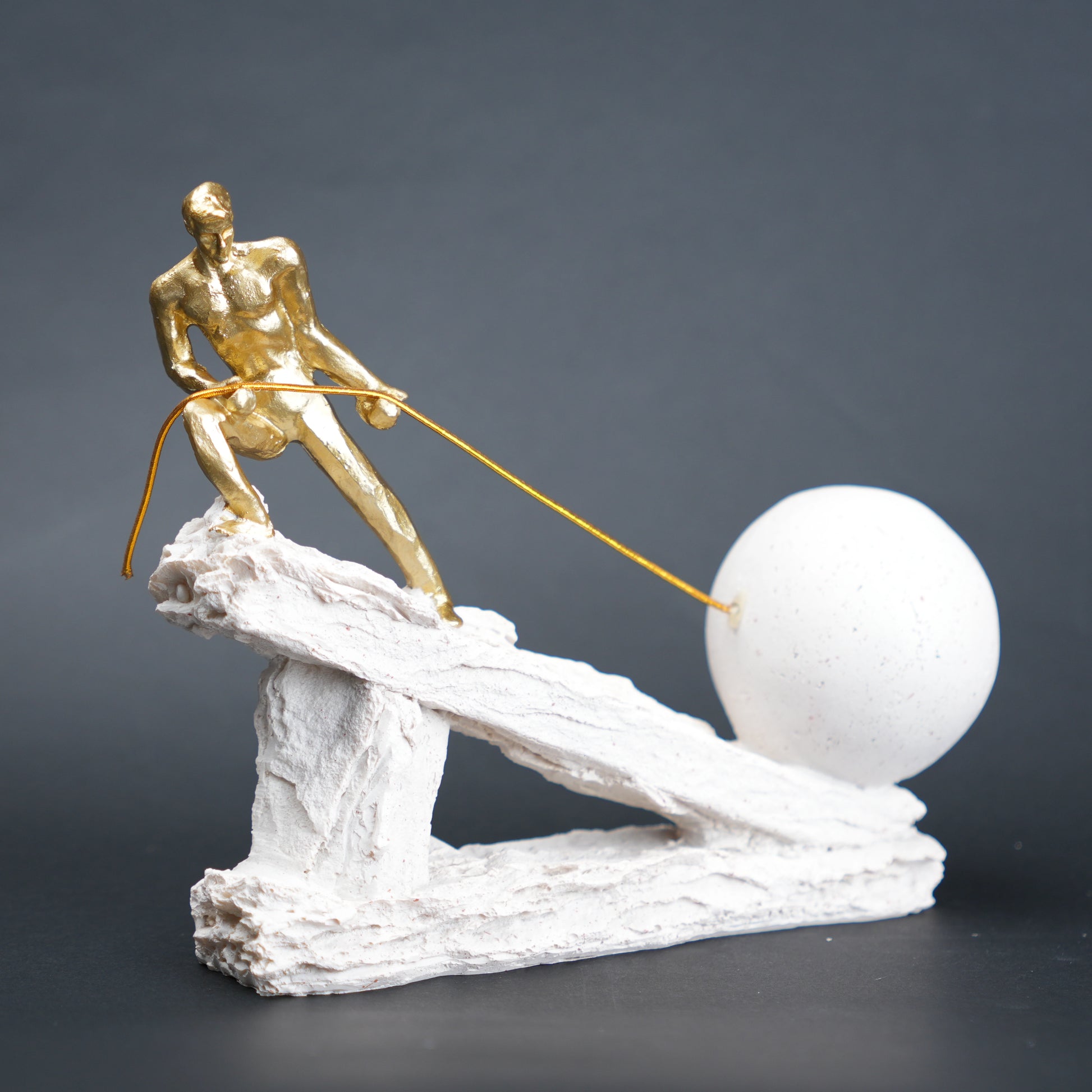 Abstract resin figurine of man pulling ball artistic tabletop decor
