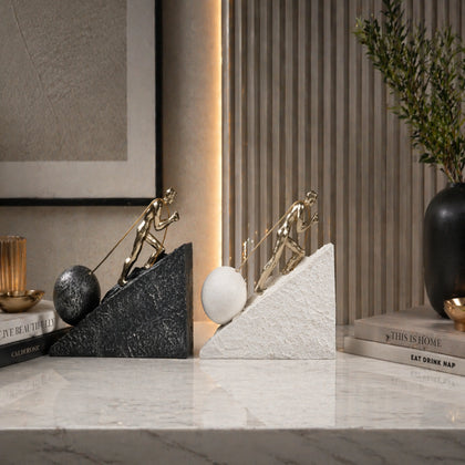 Gold climber figurine planting flag on textured stone incline base in black and white variants