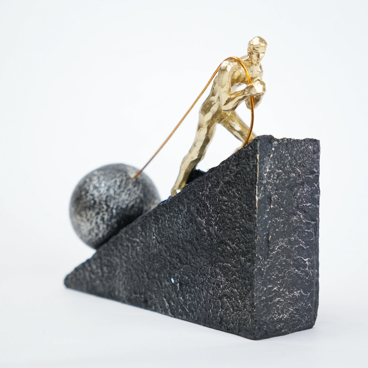 Gold climber figurine planting flag on textured stone incline base in black and white variants