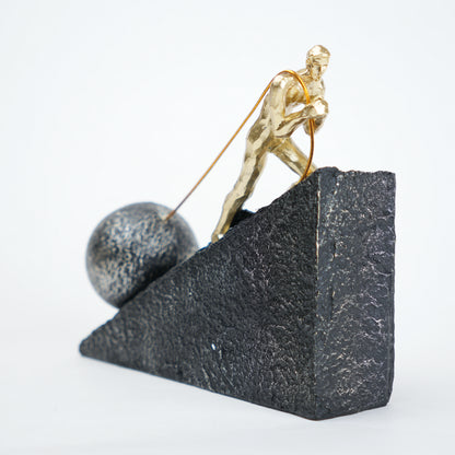 Gold climber figurine planting flag on textured stone incline base in black and white variants