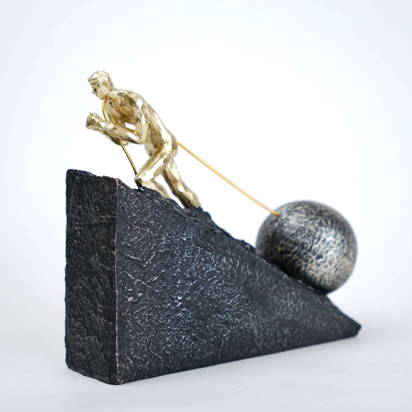 Gold climber figurine planting flag on textured stone incline base in black and white variants