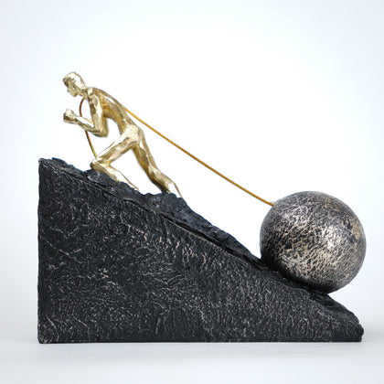Gold climber figurine planting flag on textured stone incline base in black and white variants
