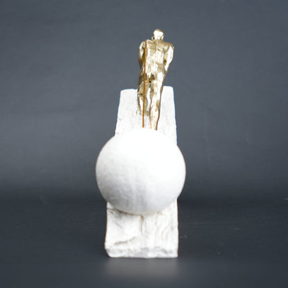 Gold climber figurine planting flag on textured stone incline base in black and white variants