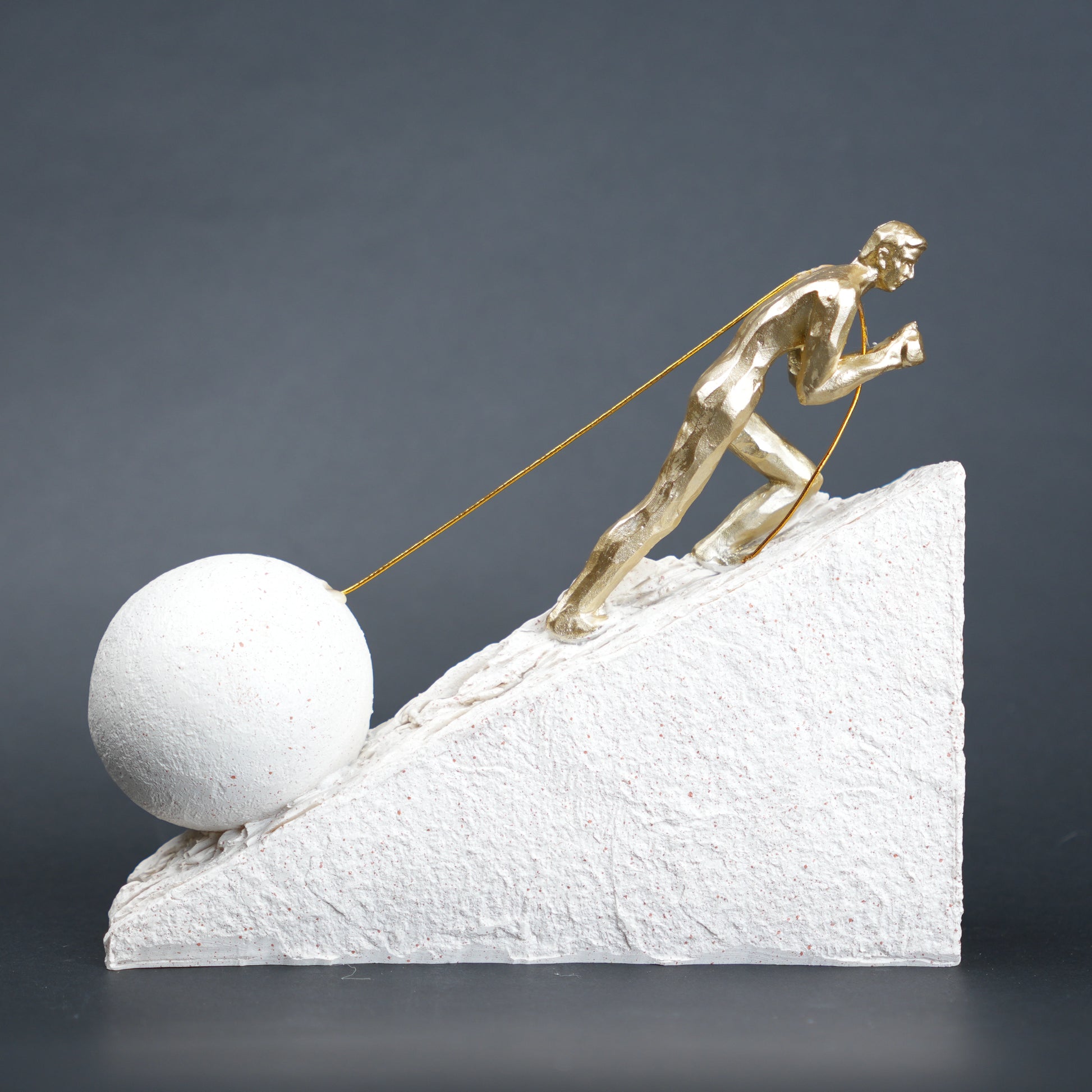 Gold climber figurine planting flag on textured stone incline base in black and white variants