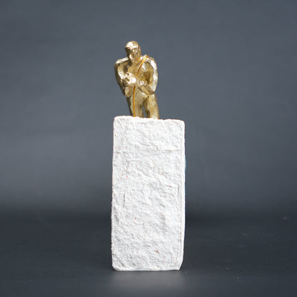 Gold climber figurine planting flag on textured stone incline base in black and white variants
