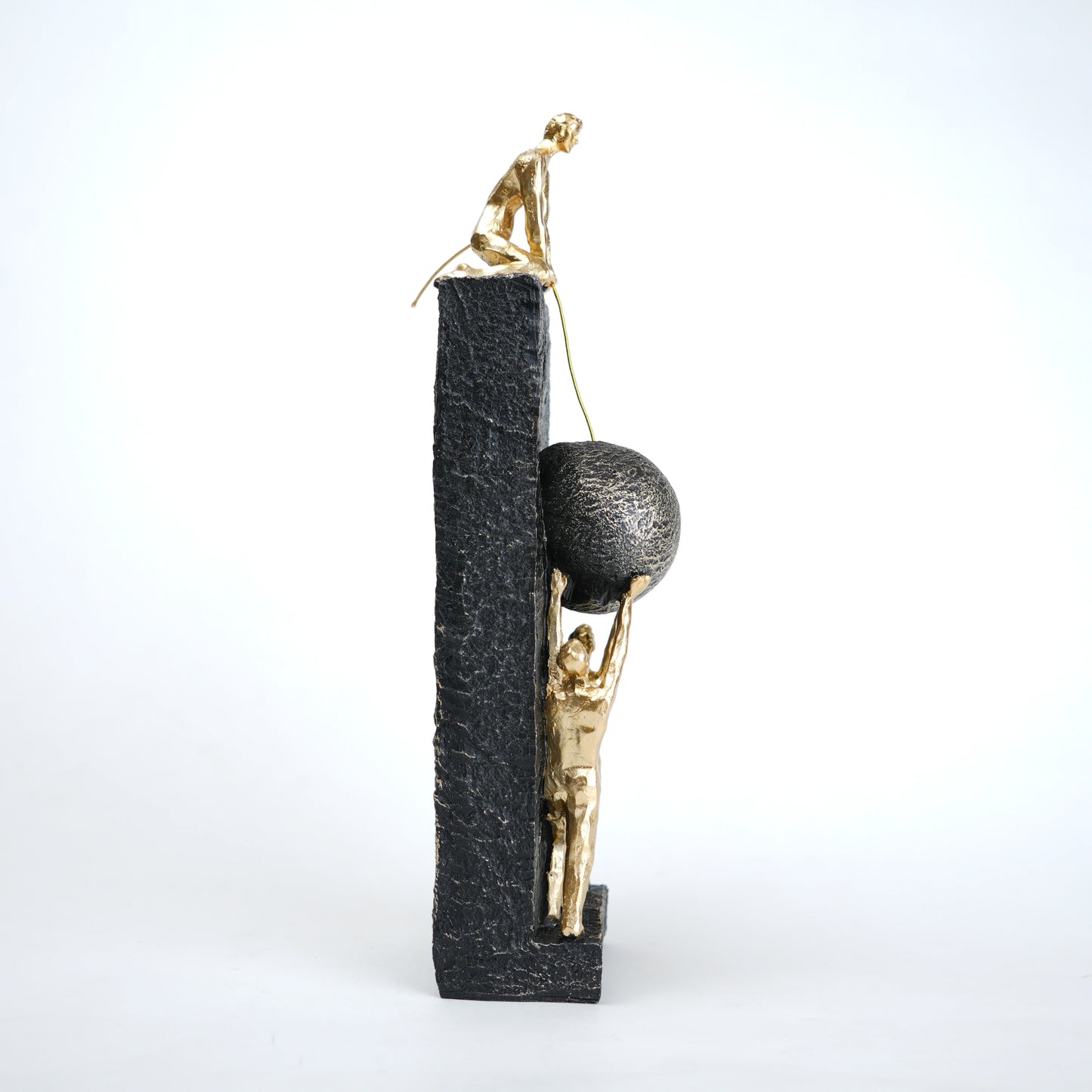 Teamwork figurine sculpture lifting sphere on textured stone base in black and white variants