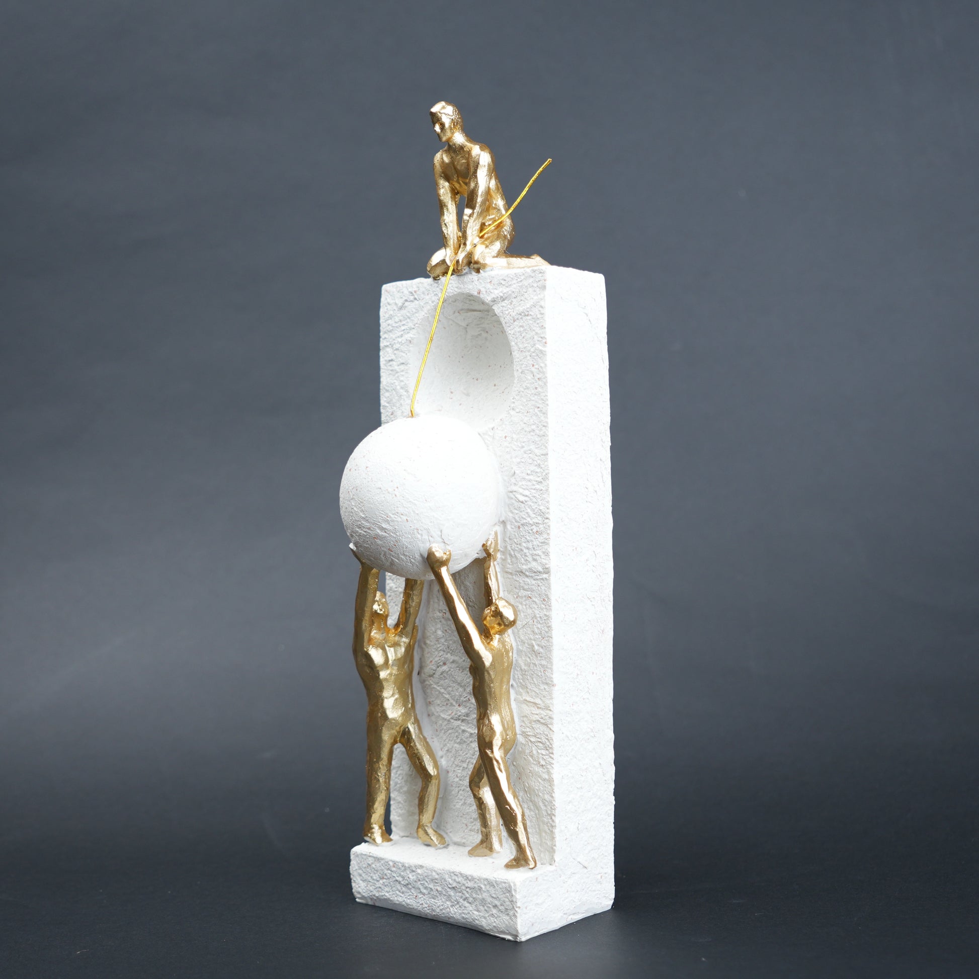 Teamwork figurine sculpture lifting sphere on textured stone base in black and white variants