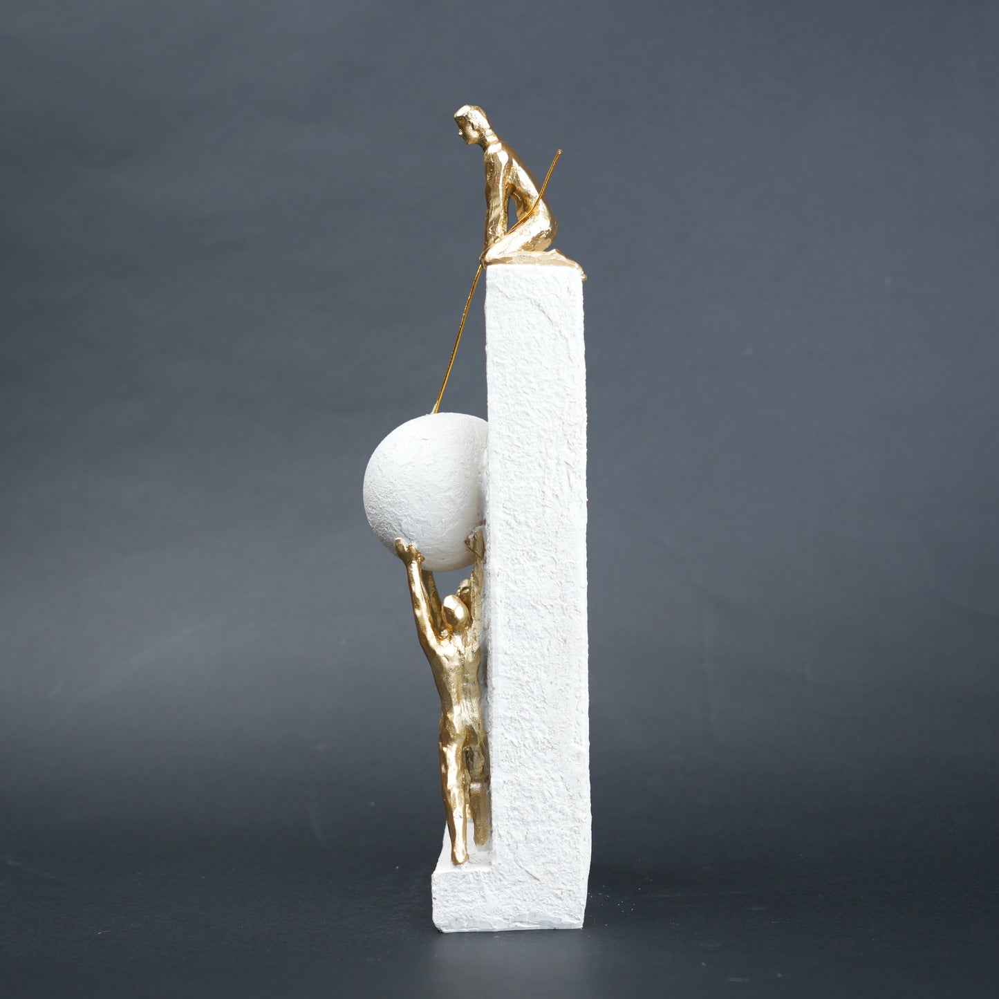 Teamwork figurine sculpture lifting sphere on textured stone base in black and white variants