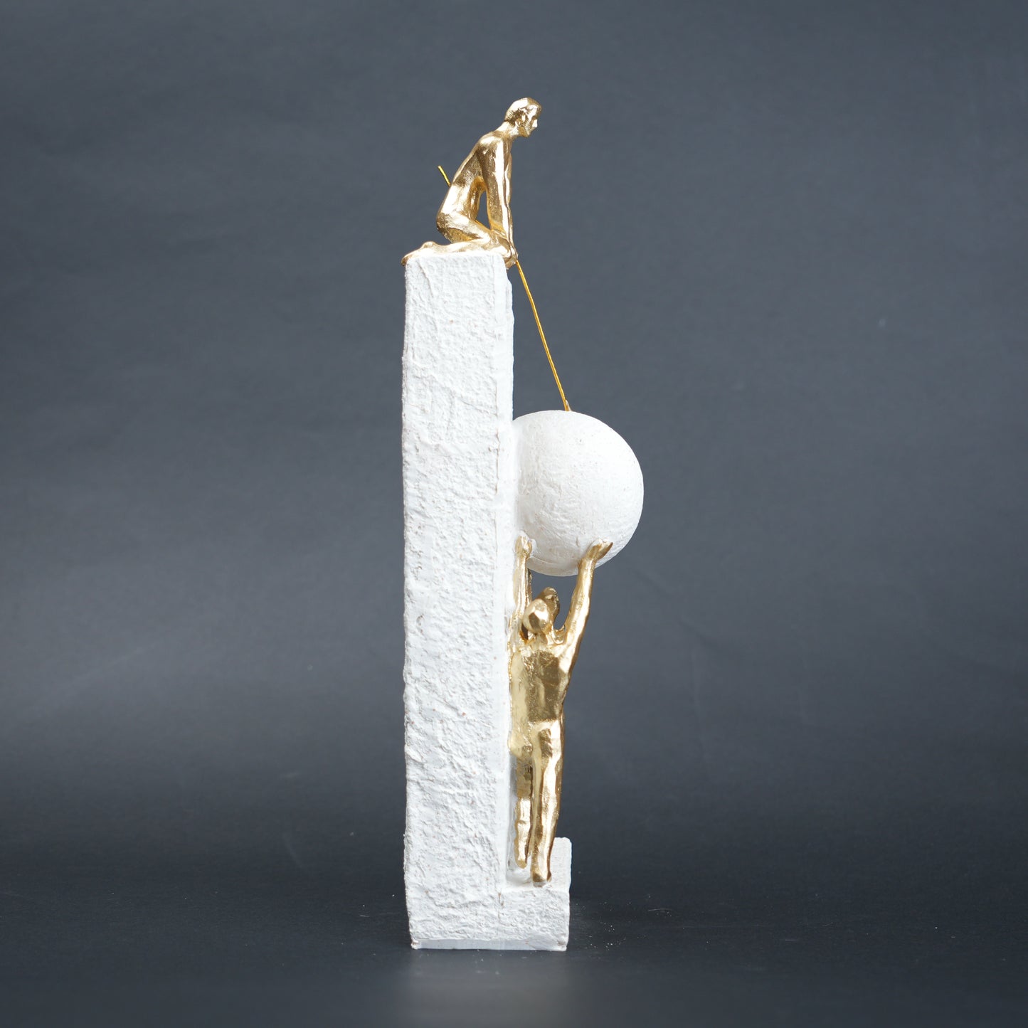 Teamwork figurine sculpture lifting sphere on textured stone base in black and white variants