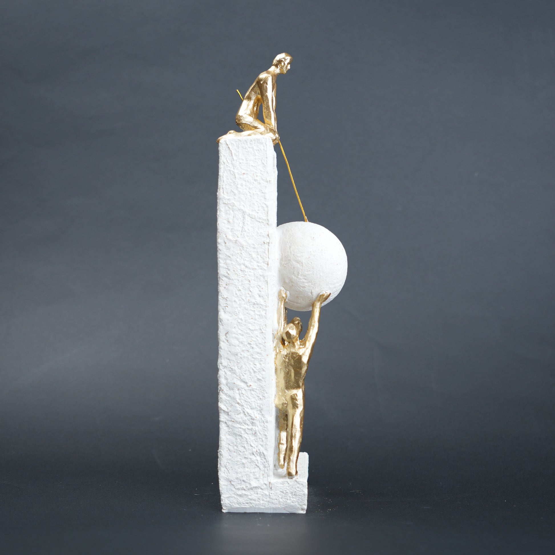 Teamwork figurine sculpture lifting sphere on textured stone base in black and white variants