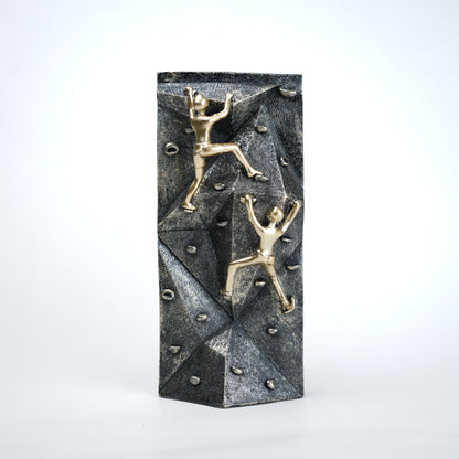 modern climbing figurine with gold climbers on textured rock base for home and office decor