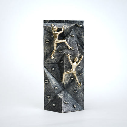 modern climbing figurine with gold climbers on textured rock base for home and office decor