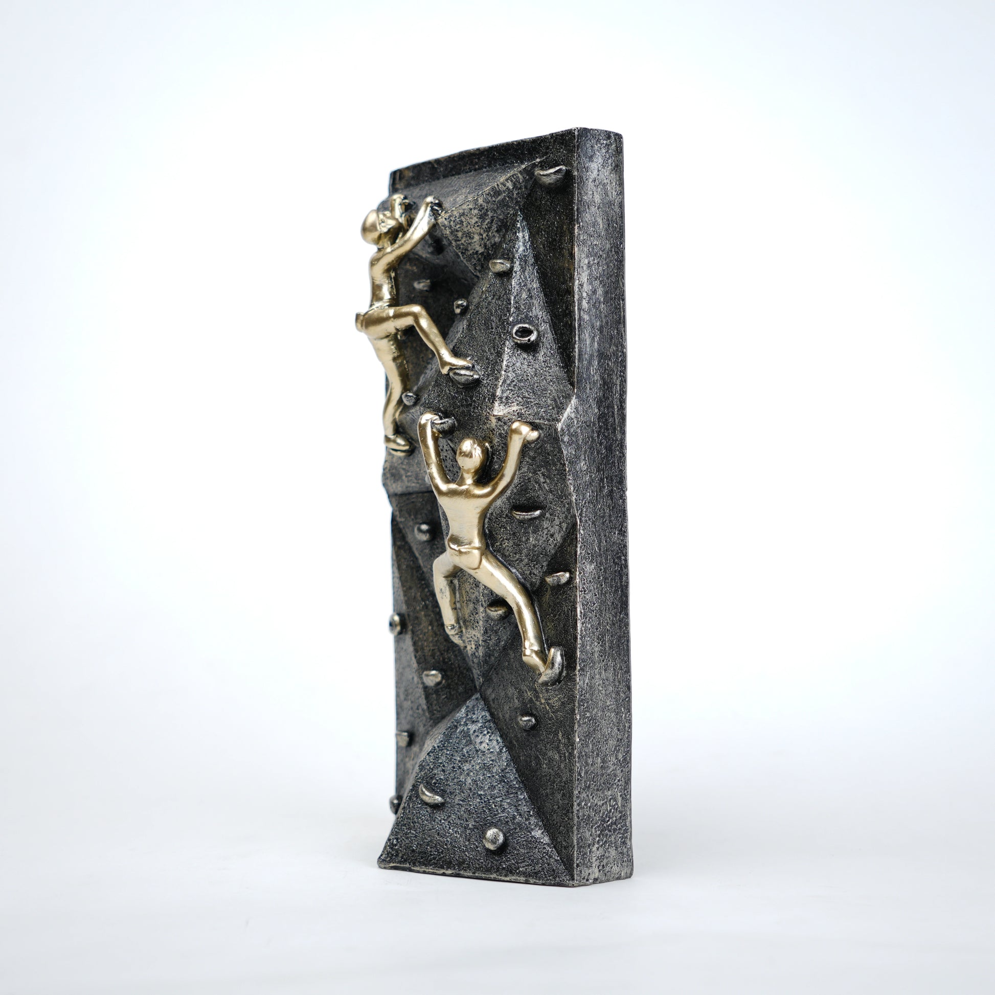 modern climbing figurine with gold climbers on textured rock base for home and office decor