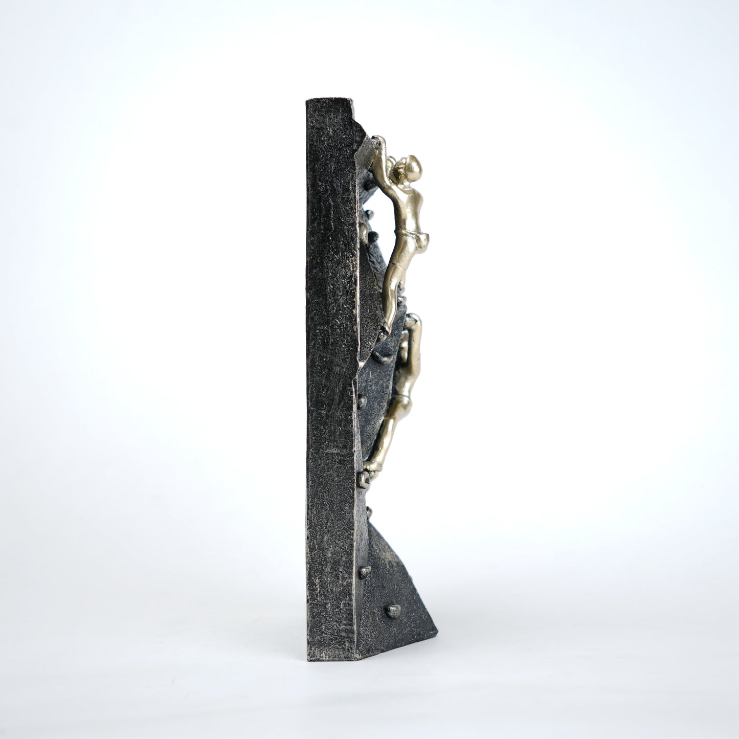 modern climbing figurine with gold climbers on textured rock base for home and office decor